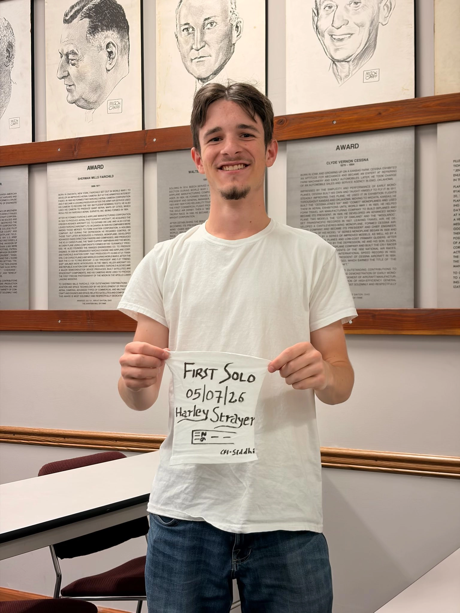 Student pilot holding a first solo shirt after soloing at Moraine Airpark in Dayton Ohio