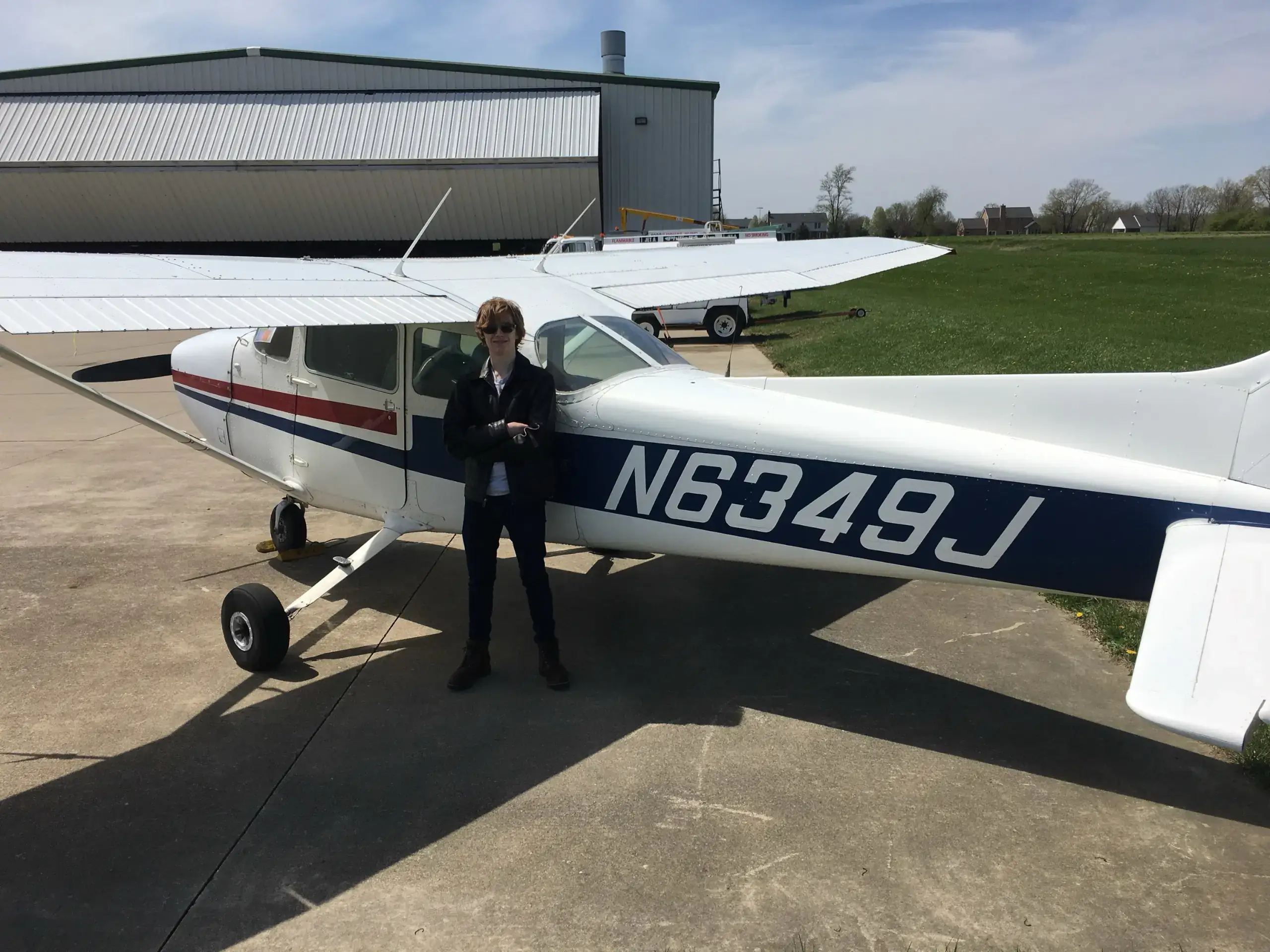 Student Mac Ottlinger standing in front of a plane at Dayton Aviation Services