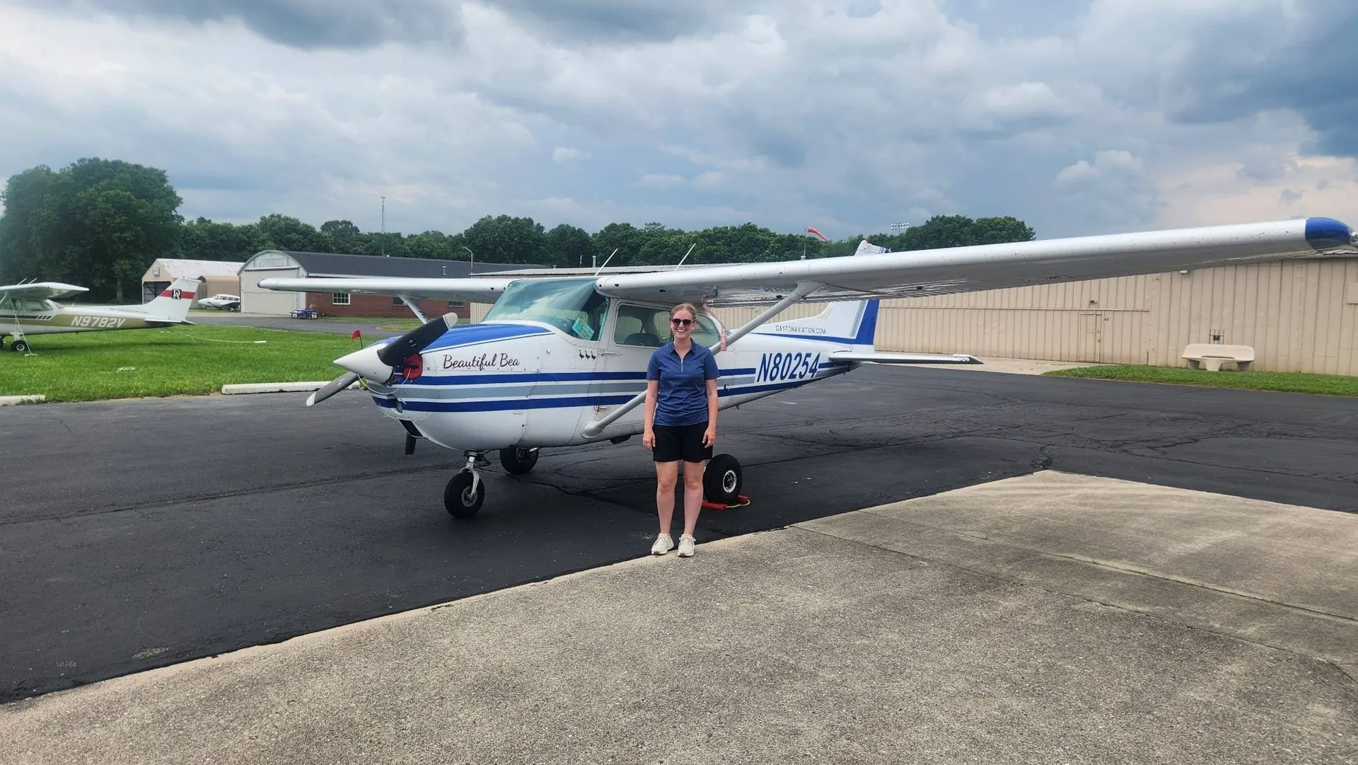 Private pilot standing beside a Cessna training aircraft at Dayton Aviation Services