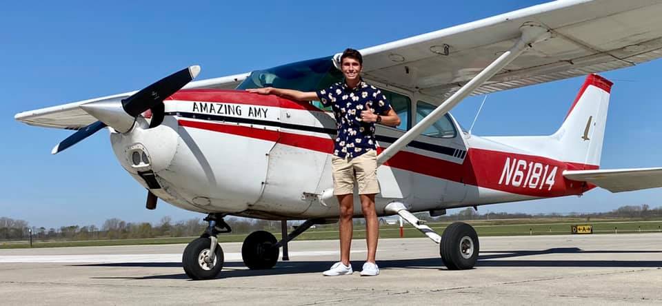 Pilot standing in front of a Cessna after completing training at Moraine Airpark